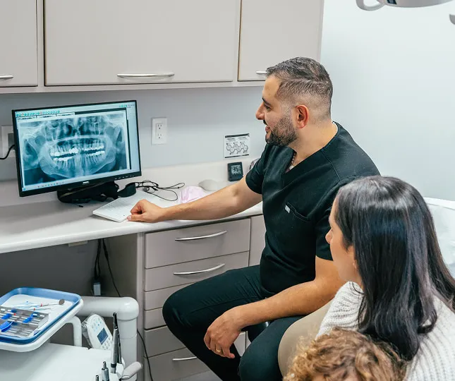 Dentist Reviewing Digital Dental X-Rays With a Patient